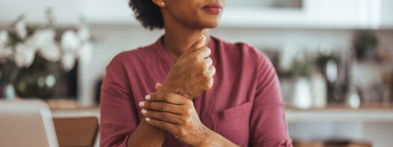 A woman holding her wrist in pain